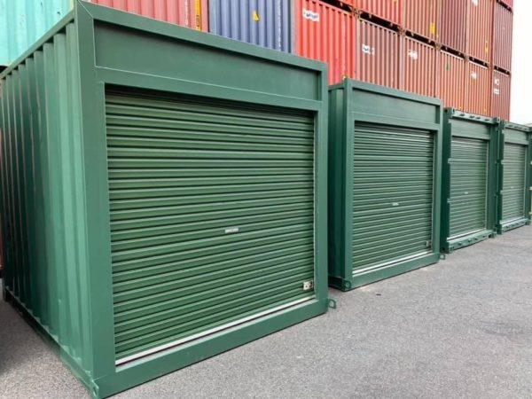 Green shipping containers with roller doors